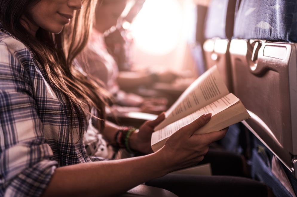 Flugzeug: Frau mit Buch